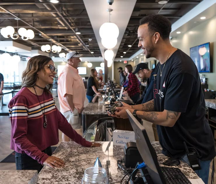A customer speaking with a team member at the dispensary counter